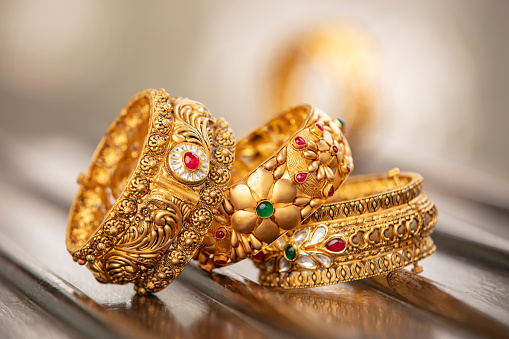 Fancy designer antique golden bracelets for woman fashion studio shot.